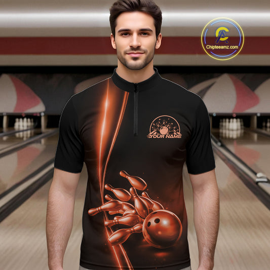 Front view of a male model in a bowling lane wearing a black quarter-zip shirt with orange bowling ball and pins artwork and dynamic bowling action visuals.