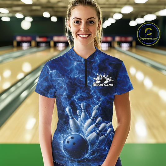 Female model wearing a blue-themed bowling quarter-zip at the bowling lane with flame-accented bowling graphics.