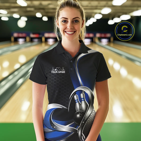 Female model in a bowling lane wearing a black and blue polo shirt with honeycomb texture and a heart-framed bowling strike graphic.