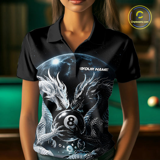 A woman wearing a black short-sleeve polo shirt with a detailed graphic print of two dragons around an 8-ball, with a green pool table blurred in the background.