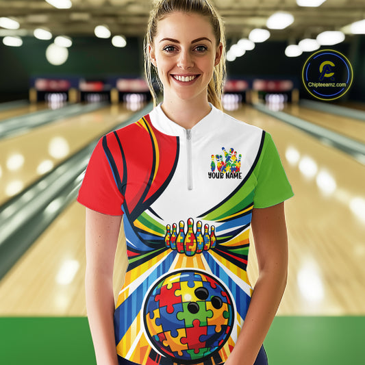 Female model in a bowling lane wearing a quarter-zip shirt, vibrant autism puzzle bowling lane illustration with colorful sports design.