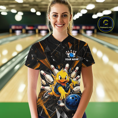Female model wearing a custom black bowling quarter-zip shirt front view featuring a playful cartoon duck, bowling ball, bowling pins and orange cracked lightning pattern at the bowling alley