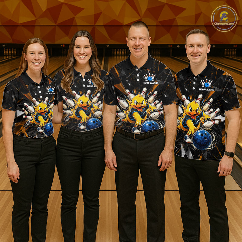 Group of four wearing custom black bowling shirts front view featuring playful cartoon duck artwork with bowling ball, bowling pins and orange cracked lightning pattern at the bowling alley