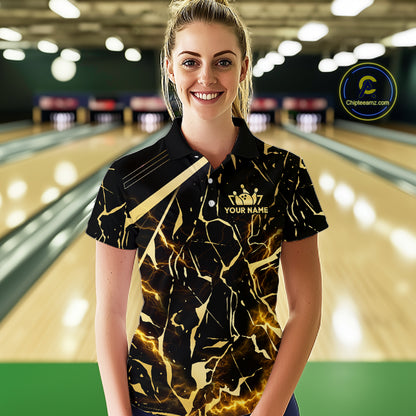Female model wearing a custom black gold bowling polo shirt front view featuring a glowing bowling ball, lightning energy effect and black gold marble crack pattern at the bowling alley