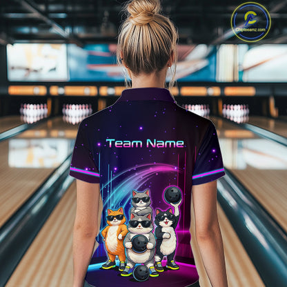 Person wearing a bowling shirt with cartoon cats and 'Team Name' text in a bowling alley.