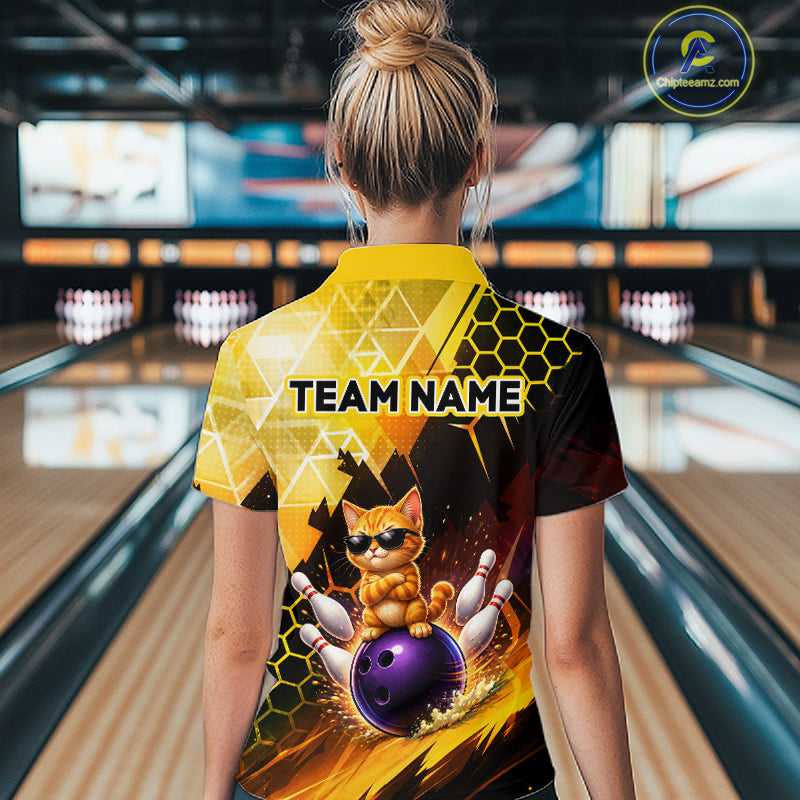 Person wearing a bowling-themed shirt with a cat design in a bowling alley.