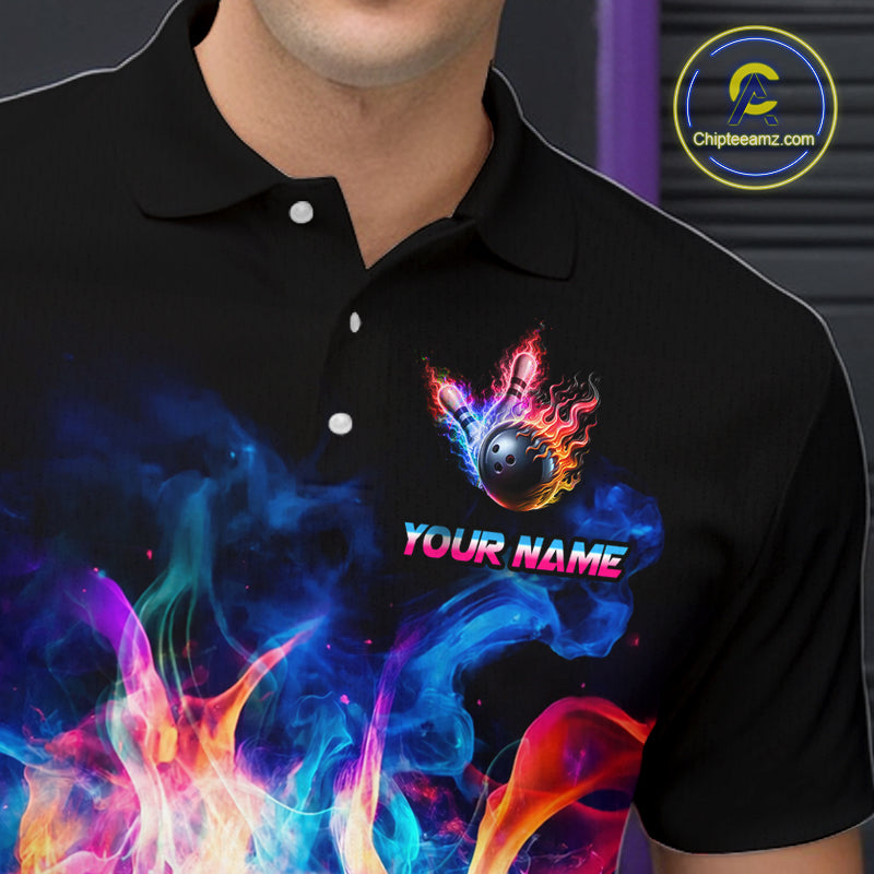 A close-up of a person wearing a black short-sleeve polo shirt with a colorful flame-and-bomb graphic and the text 'YOUR NAME' on the chest.