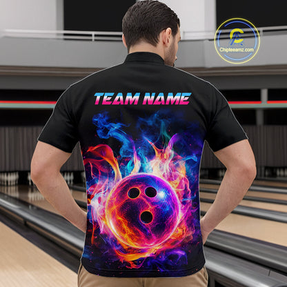 A man viewed from behind wearing a black short-sleeve bowling shirt with a large colorful graphic of a flaming bowling ball and the text 'TEAM NAME' on the back. The background shows a bowling alley interior.