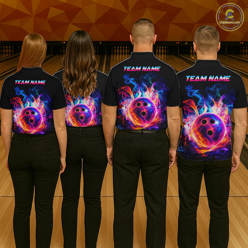 Four people standing in a bowling alley, viewed from behind, wearing matching black short-sleeve shirts with a vibrant neon bowling pin and flame graphic on the back, along with 'TEAM NAME' text.