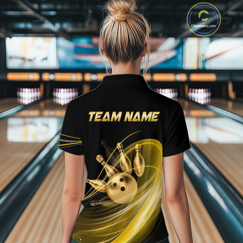 Person wearing a black bowling shirt with 'TEAM NAME' on the back in a bowling alley.