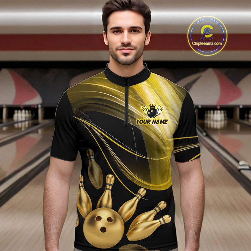 Man wearing a black and gold bowling jersey with a bowling alley in the background