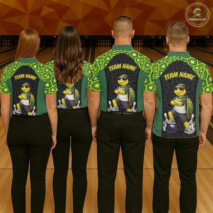 Four people standing with their backs to the camera in a bowling alley, wearing matching green and black bowling shirts with a cartoon turtle graphic and 'TEAM NAME' printed on the back.