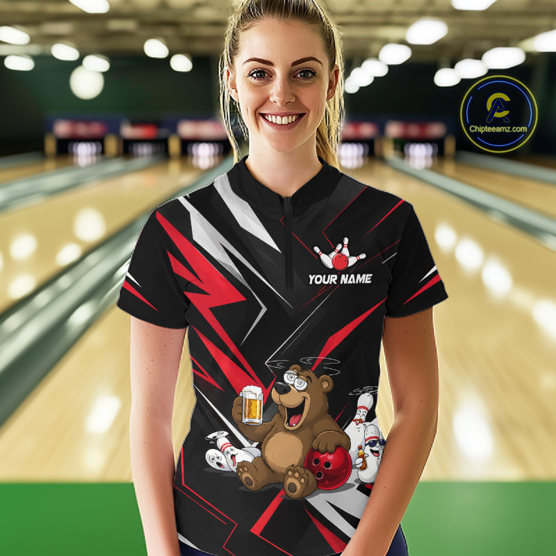 Person wearing a custom bowling shirt with a bear and bowling design in a bowling alley.