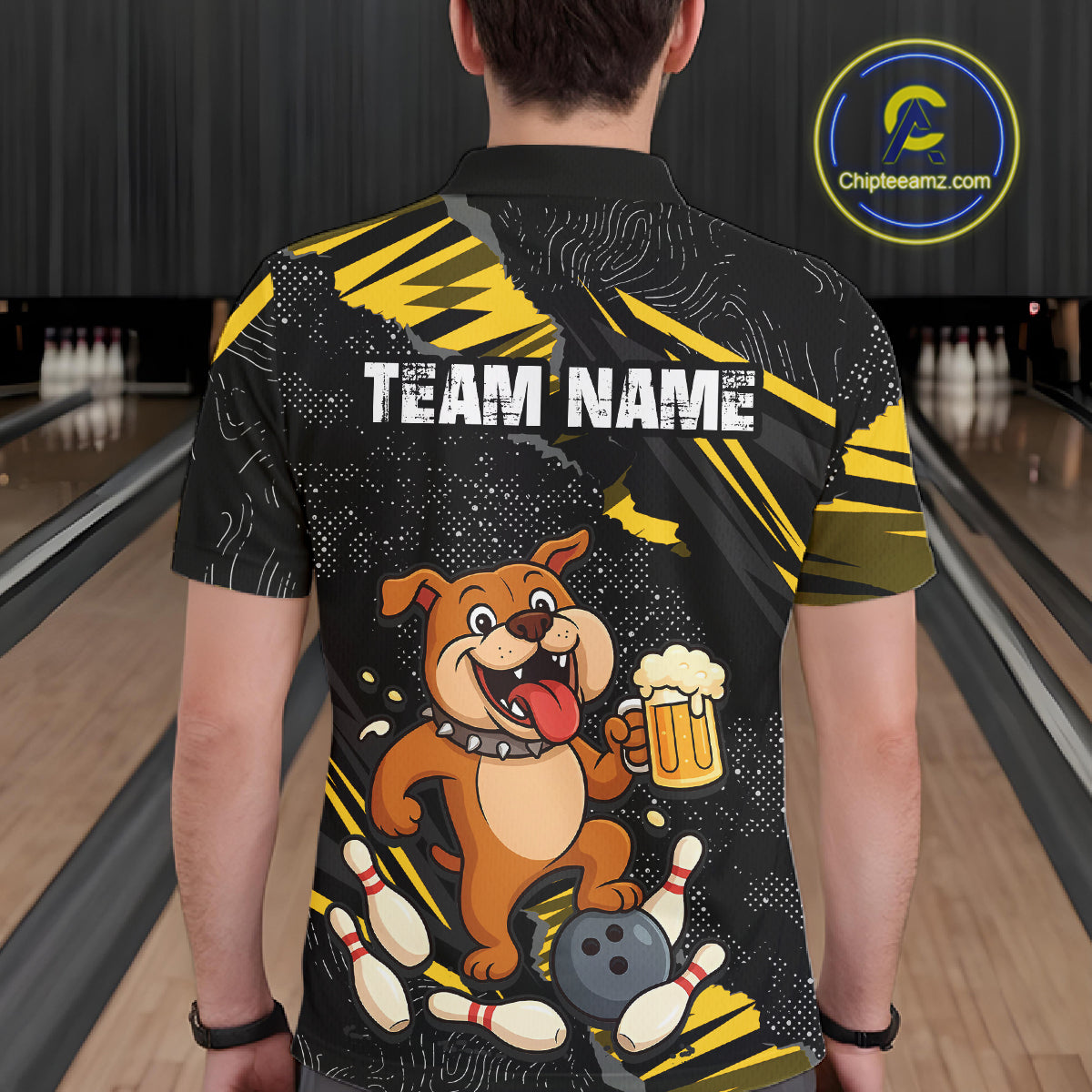 A man wearing custom black yellow bulldog bowling polo shirt back view featuring a bowling ball, beer mug and yellow paint splash pattern, displaying Team Name, at the bowling alley
