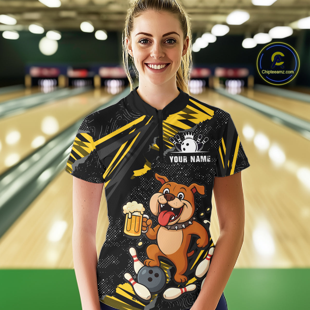 A woman wearing custom black yellow bulldog bowling polo shirt front view featuring a bowling ball, beer mug and yellow paint splash pattern, displaying Team Name, at the bowling alley