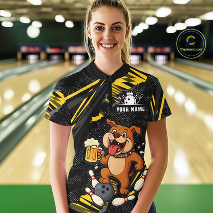 A woman wearing custom black yellow bulldog bowling polo shirt front view featuring a bowling ball, beer mug and yellow paint splash pattern, displaying Team Name, at the bowling alley
