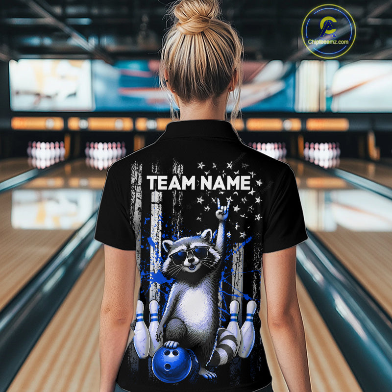 Person wearing a black shirt with a raccoon graphic and 'TEAM NAME' text in a bowling alley.