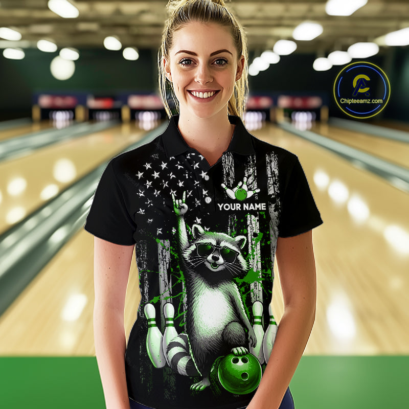 Woman wearing a black shirt with a raccoon design in a bowling alley.