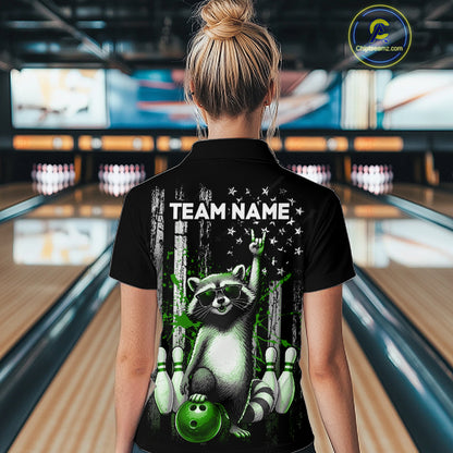 Person wearing a black shirt with a raccoon graphic and 'TEAM NAME' text in a bowling alley.