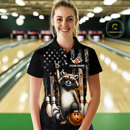 Woman wearing a black shirt with a raccoon graphic in a bowling alley.