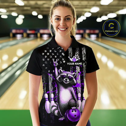 Woman wearing a black shirt with a raccoon design in a bowling alley.
