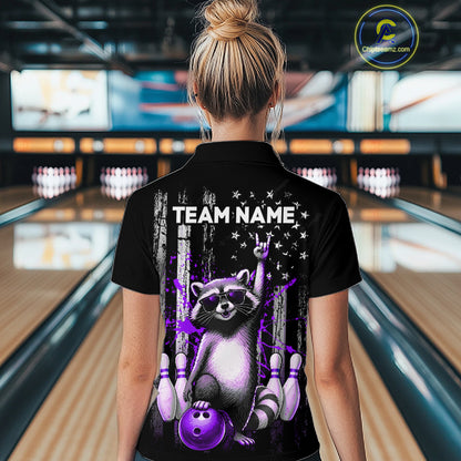 Person wearing a black shirt with a raccoon graphic and 'TEAM NAME' text in a bowling alley.