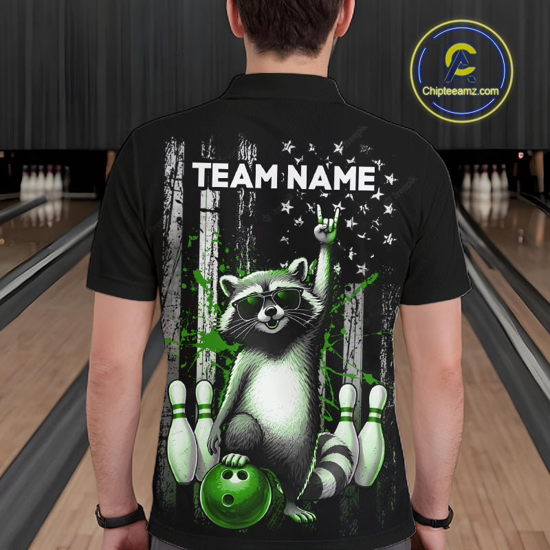 Person wearing a black t-shirt with a raccoon graphic and 'Team Name' text in a bowling alley.