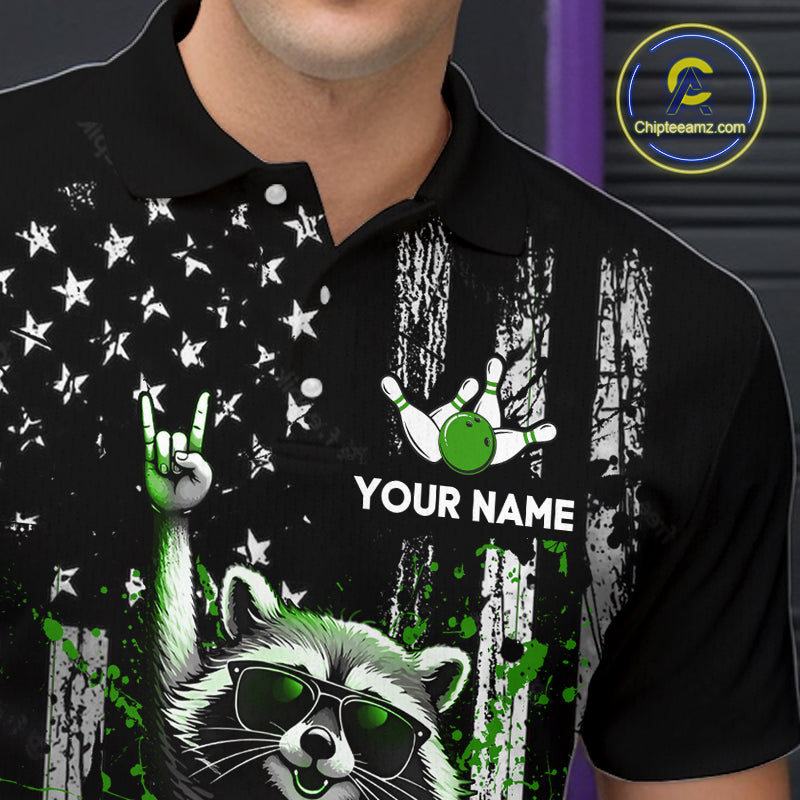 Black polo shirt with a raccoon graphic, green elements, and 'Your Name' text on a dark background.