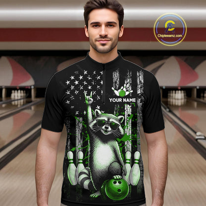 Man wearing a black shirt with a raccoon design in a bowling alley.