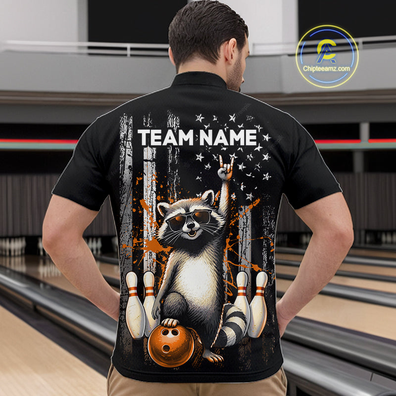 Person wearing a black shirt with a raccoon graphic and 'TEAM NAME' text in a bowling alley.