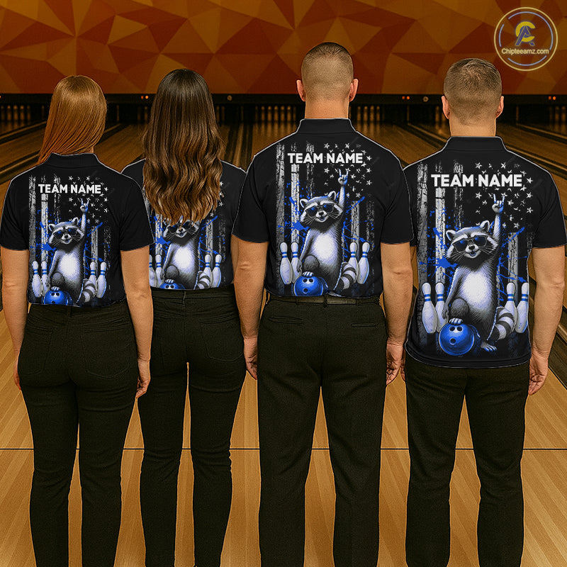 Four people wearing black shirts with a raccoon and bowling design on a bowling alley background.