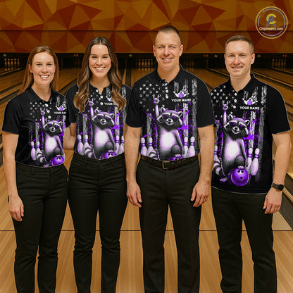Four people wearing matching black shirts with a raccoon design on a bowling alley.