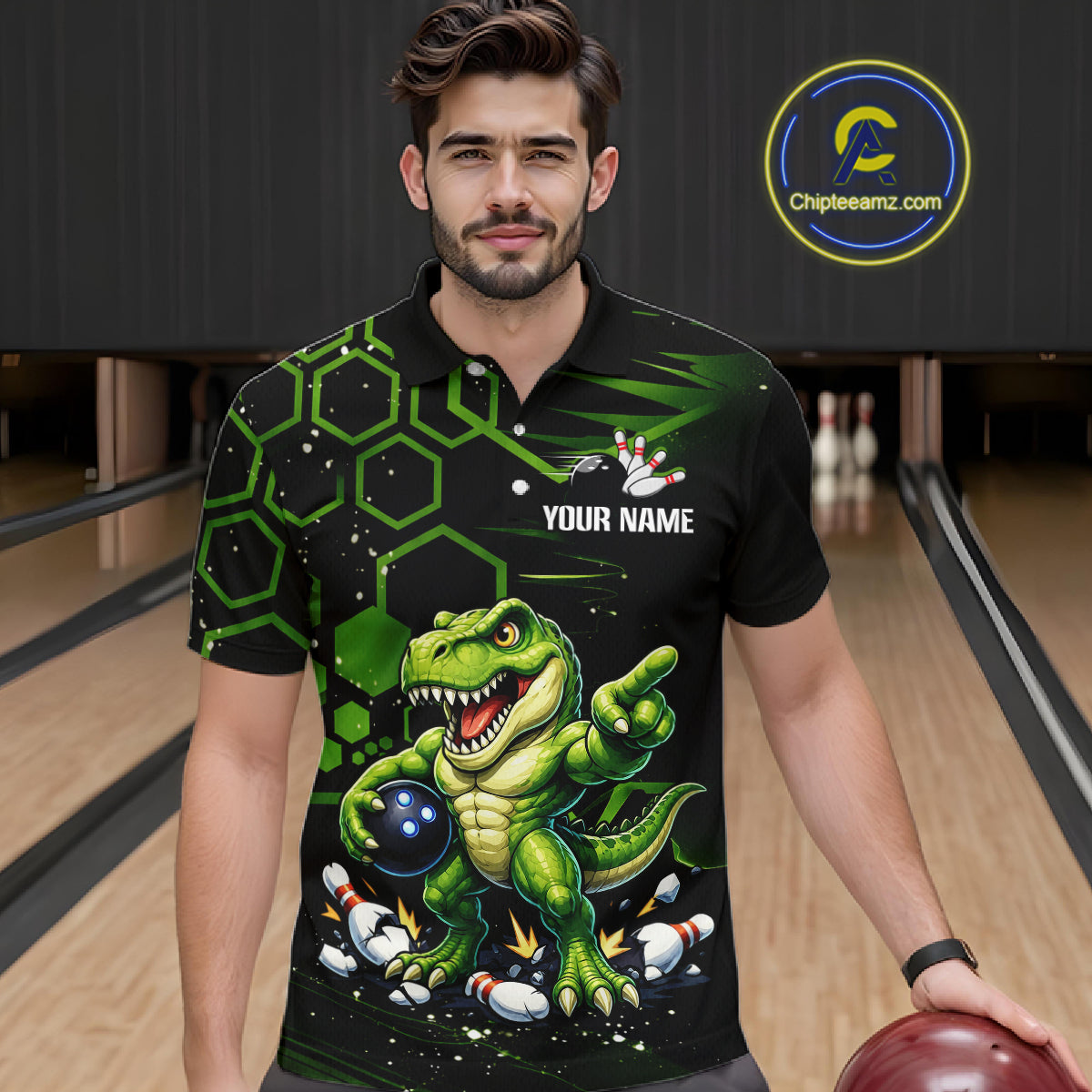 A man wearing a black short-sleeve bowling polo shirt with a green cartoon dinosaur graphic, bowling pins, and the text 'YOUR NAME' on the chest. The background shows bowling lanes, and a circular 'Chipleeamz.
