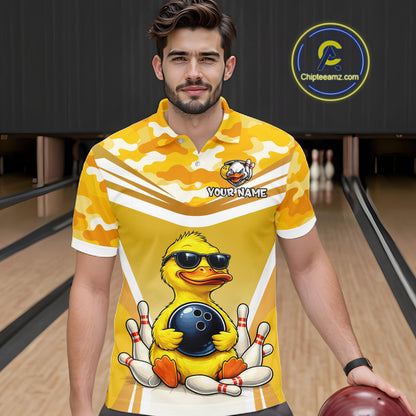 Male model wearing a custom yellow duck bowling polo shirt front view featuring a cool cartoon duck wearing sunglasses, bowling ball, bowling pins and yellow camouflage pattern at the bowling alley