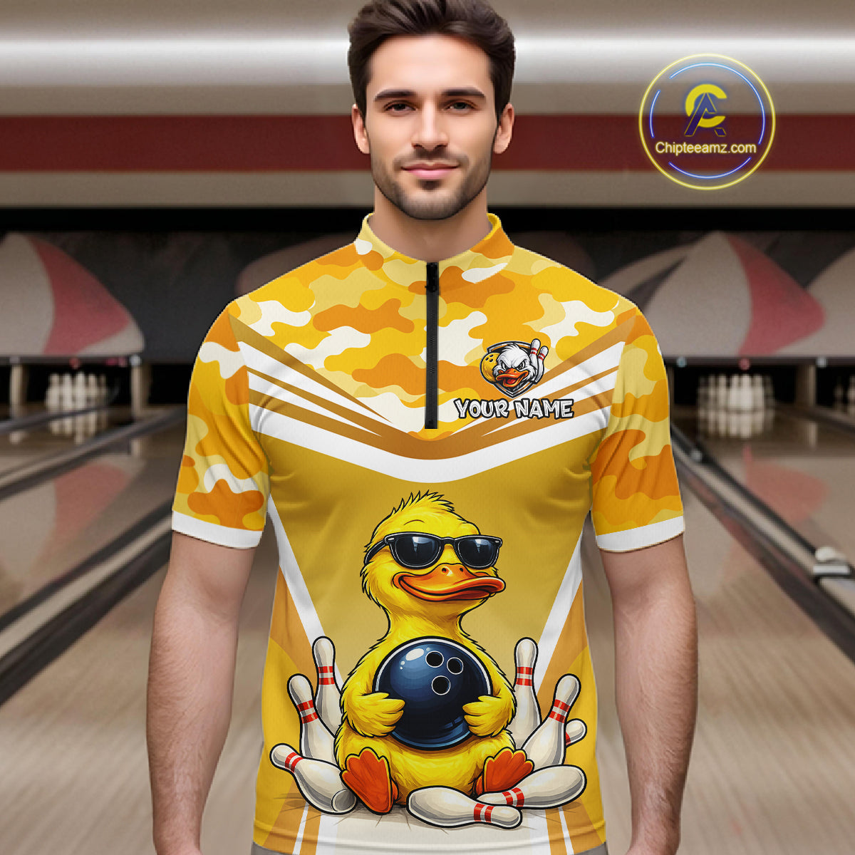 Male model wearing a custom yellow duck bowling quarter-zip shirt front view featuring a cool cartoon duck wearing sunglasses, bowling ball, bowling pins and yellow camouflage pattern at the bowling alley