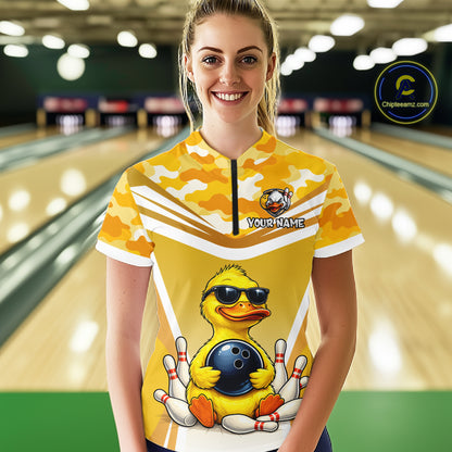 Female model wearing a custom yellow duck bowling quarter-zip shirt front view featuring a cool cartoon duck wearing sunglasses, bowling ball, bowling pins and yellow camouflage pattern at the bowling alley