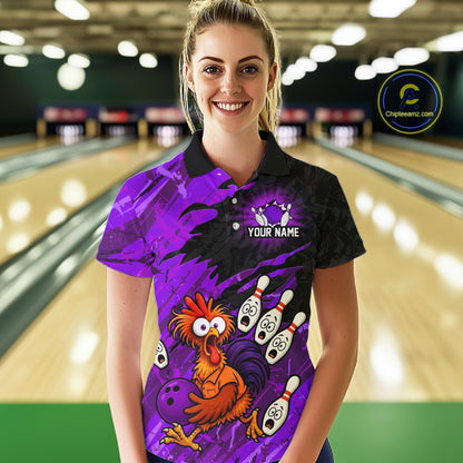 Female model wearing a custom purple chicken bowling polo shirt with a cartoon mascot graphic, bowling pins, bowling ball and purple brush stroke pattern, front view at the bowling alley