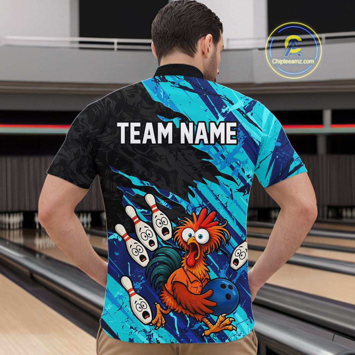Male model wearing a custom cyan chicken bowling quarter-zip shirt back view displaying the personalized team name above a colorful bowling mascot graphic at the bowling alley