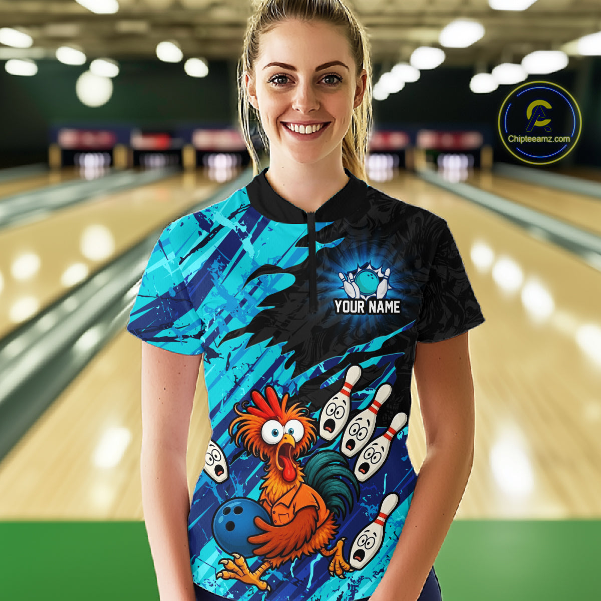 Female model wearing a custom cyan chicken bowling quarter-zip shirt front view featuring a colorful bowling mascot graphic, bowling pins, bowling ball and cyan abstract brush stroke pattern at the bowling alley