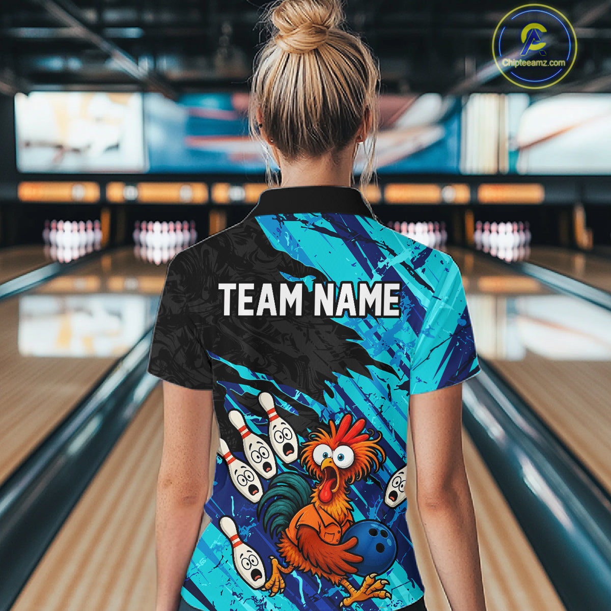 Female model wearing a custom cyan chicken bowling polo shirt back view displaying the personalized team name above a colorful bowling mascot graphic at the bowling alley