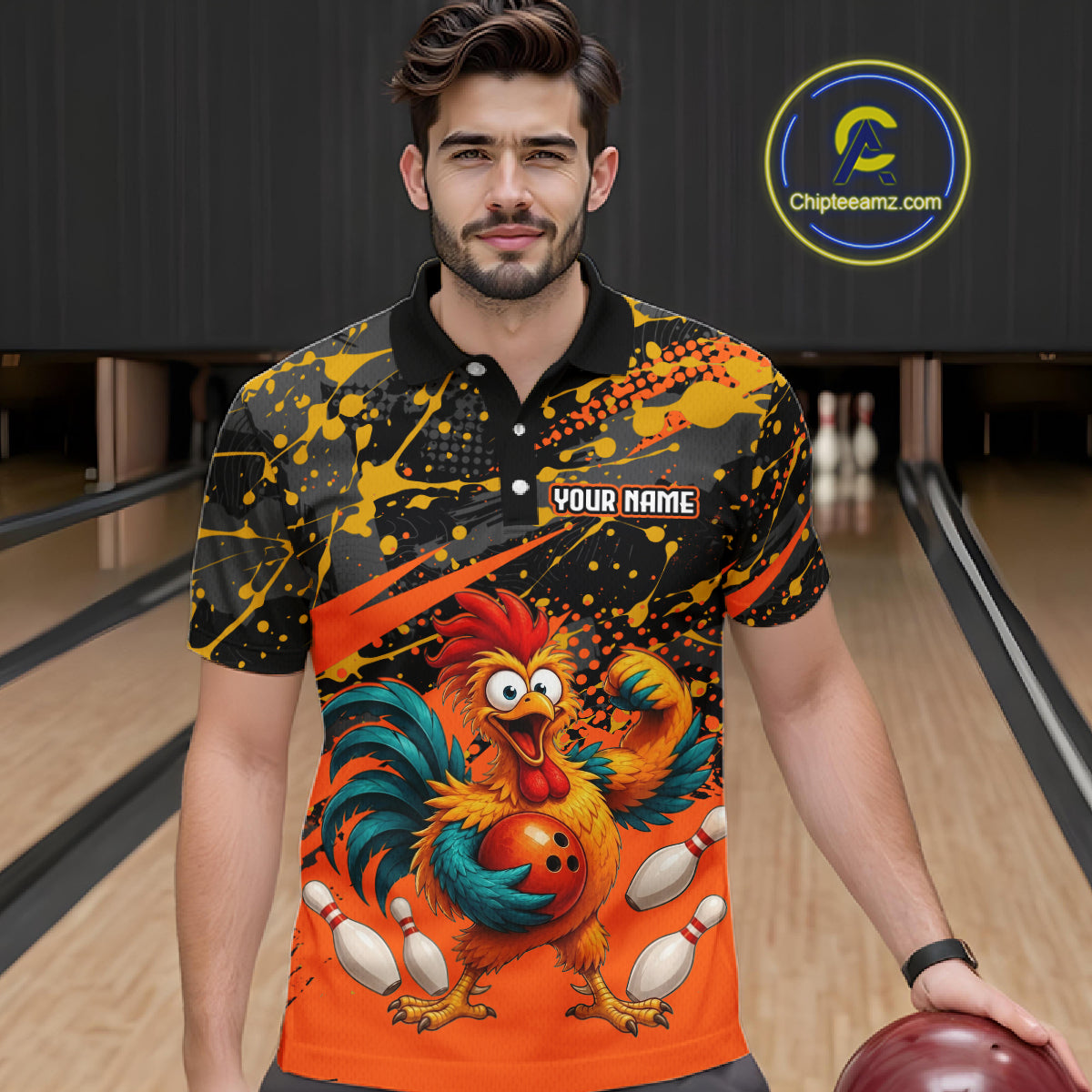 Male model wearing a custom orange rooster bowling polo shirt front view featuring a fierce cartoon rooster, bowling ball, bowling pins and black orange paint splatter pattern at the bowling alley