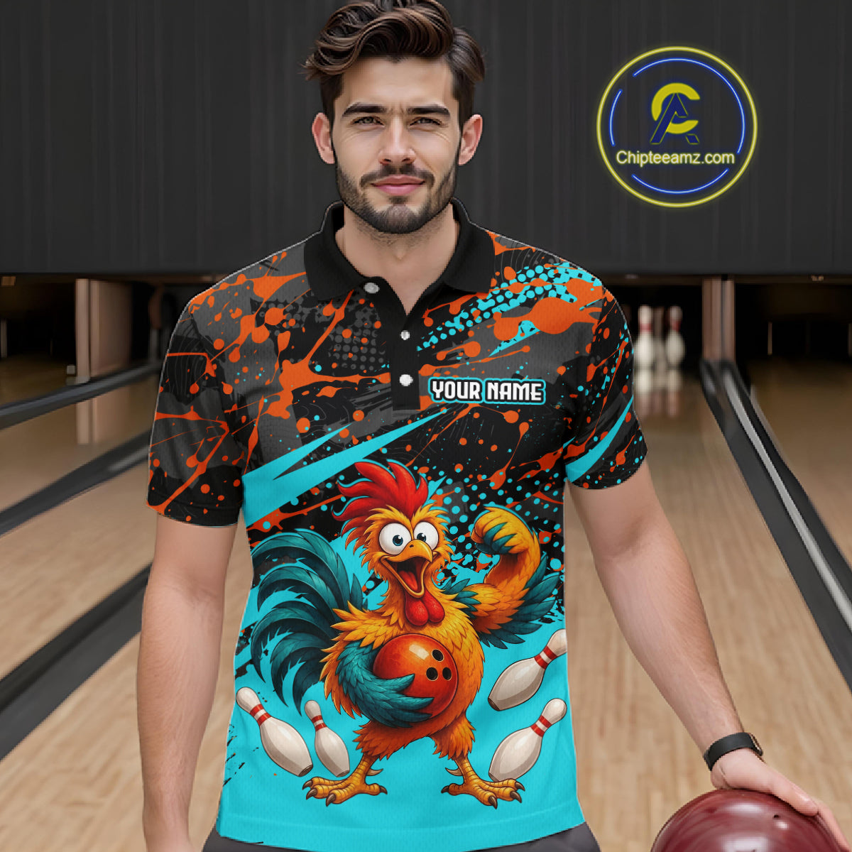 Male model wearing a custom black red rooster bowling polo shirt front view featuring a fierce cartoon rooster, bowling ball, bowling pins and orange turquoise paint splash pattern at the bowling alley