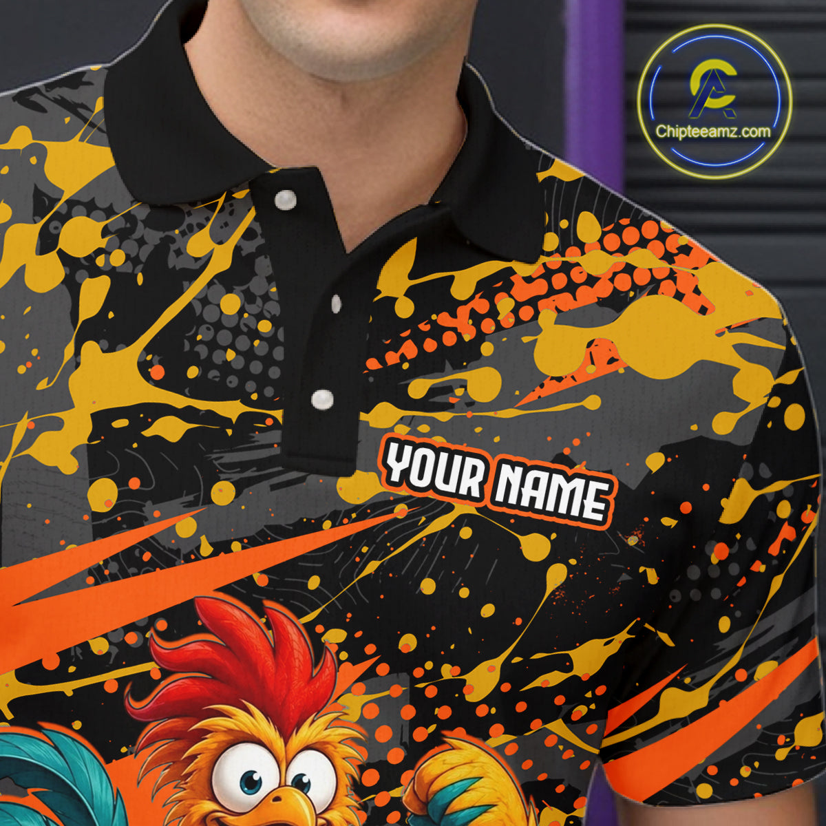 Close-up front view of a custom orange rooster bowling polo shirt showing the personalized player name, fierce cartoon rooster graphic and black orange paint splatter design