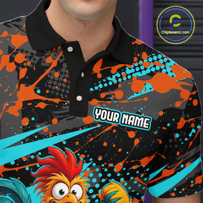 Male model wearing a custom black turquoise rooster bowling polo shirt front view featuring a fierce cartoon rooster, bowling ball, bowling pins and turquoise orange paint splash pattern at the bowling alley