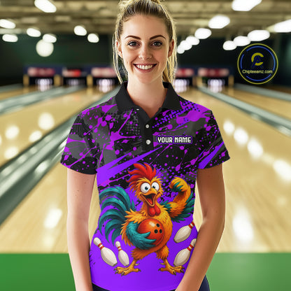Female model wearing a custom purple rooster bowling polo shirt front view featuring a fierce cartoon rooster, bowling ball, bowling pins and purple black paint splash pattern at the bowling alley