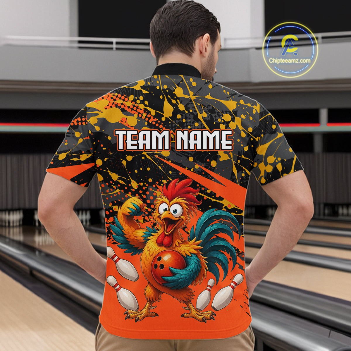 Male model wearing a custom orange rooster bowling quarter-zip shirt back view displaying the personalized team name above a fierce cartoon rooster graphic at the bowling alley