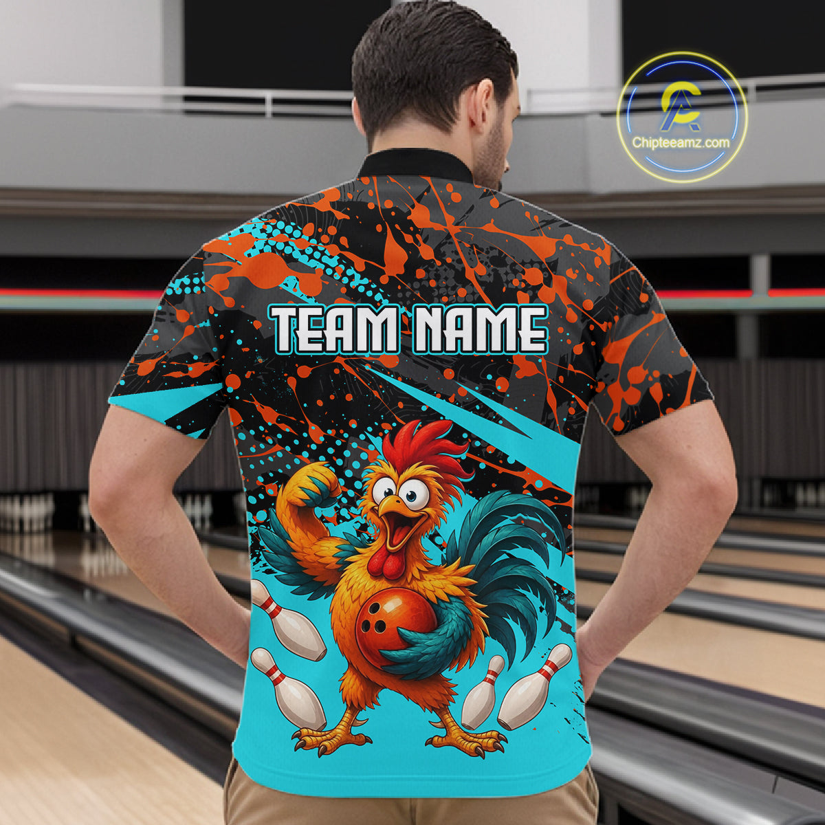 Male model wearing a custom black turquoise rooster bowling quarter-zip shirt back view displaying the personalized team name above a fierce cartoon rooster graphic at the bowling alley