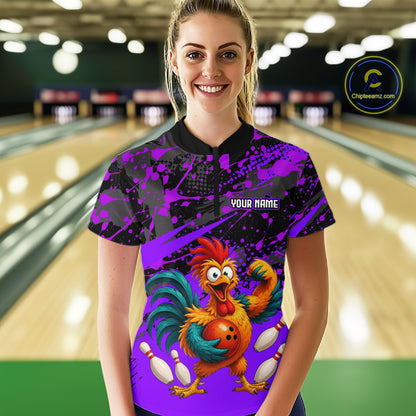 Female model wearing a custom purple rooster bowling quarter-zip shirt front view featuring a fierce cartoon rooster, bowling ball, bowling pins and purple black paint splash pattern at the bowling alley