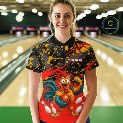Female model wearing a custom black red rooster bowling quarter-zip shirt front view featuring a fierce cartoon rooster, bowling ball, bowling pins and red black paint splash pattern at the bowling alley