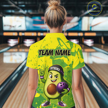 Load image into Gallery viewer, Person wearing a yellow bowling shirt with a cartoon avocado character in a bowling alley.